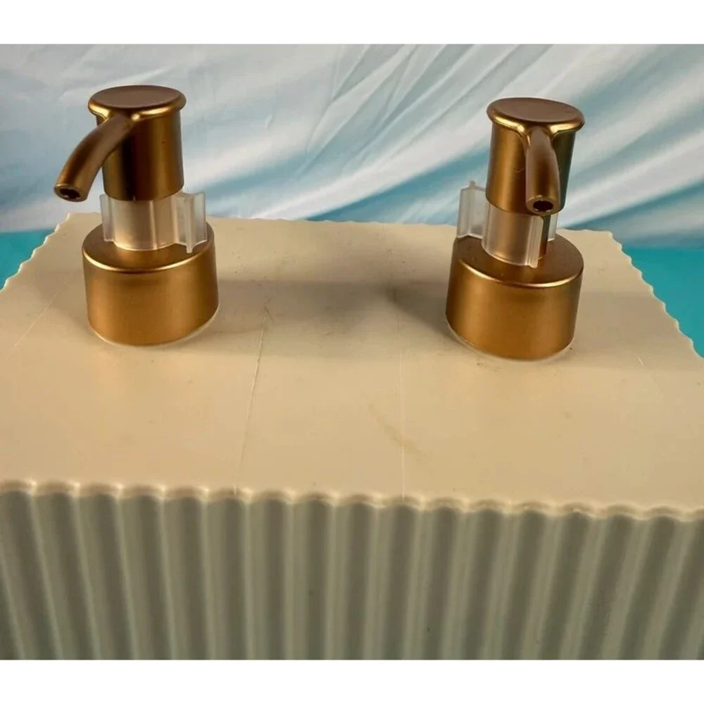 Cream colored ribbed dual-pump soap and lotion dispenser